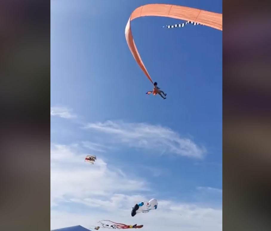 Girl with kite pulled into sky by wind in Taiwan