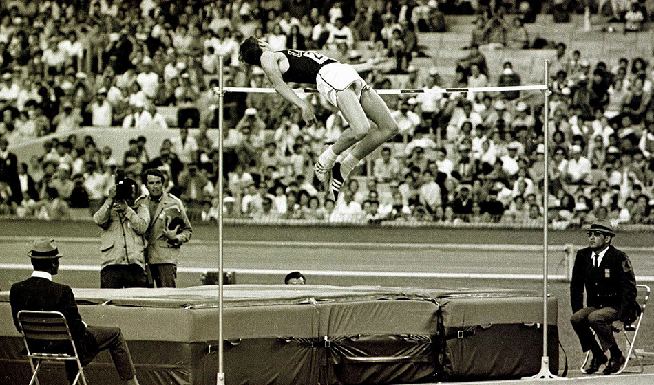 Dick Fosbury flops to an Olympic high jump record on this day in history