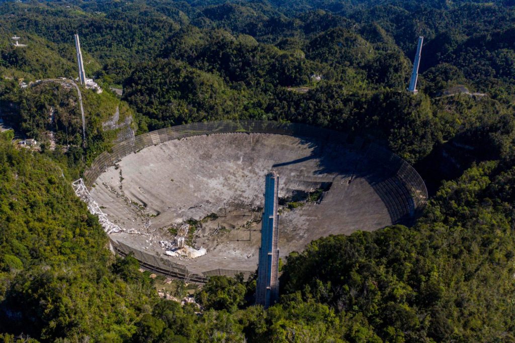 Unbiased news without politics This aerial view shows the damage at the Arecibo Observatory after one of the main cables holding the receiver broke in Arecibo, Puerto Rico, on December 1, 2020. - The radio telescope in Puerto Rico, which once starred in a James Bond film, collapsed Tuesday when its 900-ton receiver platform fell 450 feet (140 meters) and smashed onto the radio dish below.Nonpartisan News without politics