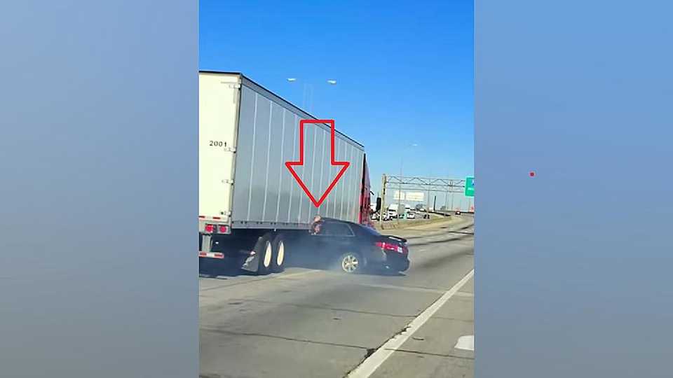 Semi truck drags pinned car down highway in shocking video