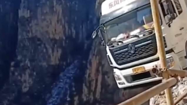 Container truck dangles over the edge of 330ft cliff