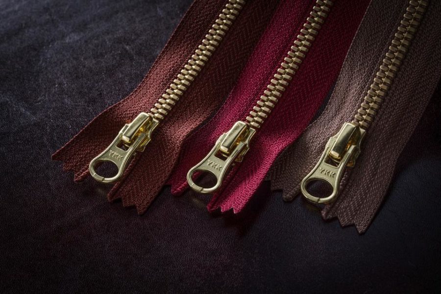 Ever Wonder Why Most Zippers Say “YKK” on the Pull-tab?